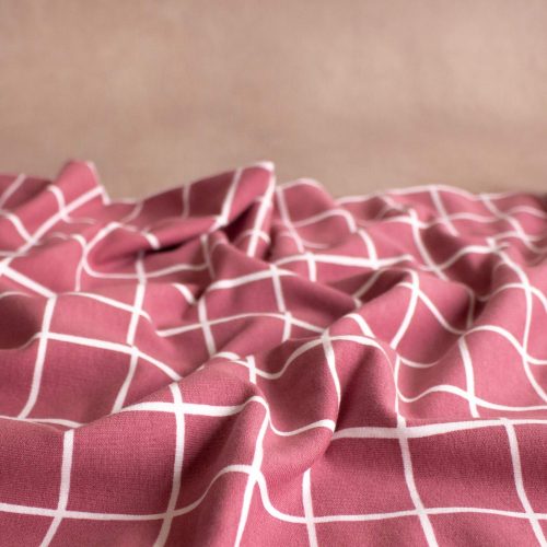 pink brushed eat fabric with white grid print scrunched up