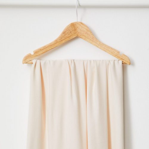 cream fabric hanging on hanger