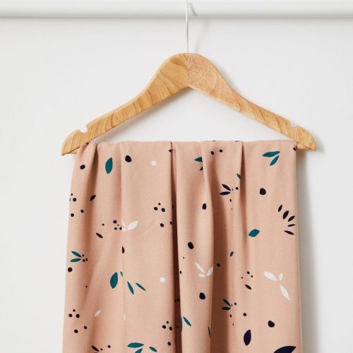 rose petal print fabric hanging on a hanger by mind the maker