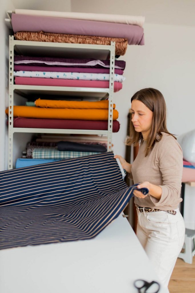 Polina, owner of Good Fabric store folding fabric
