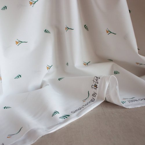 roo-tid organic cotton poplin fabric in with small delicate flowers