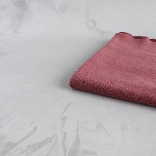 Dark rose cotton towel fabric folded neatly