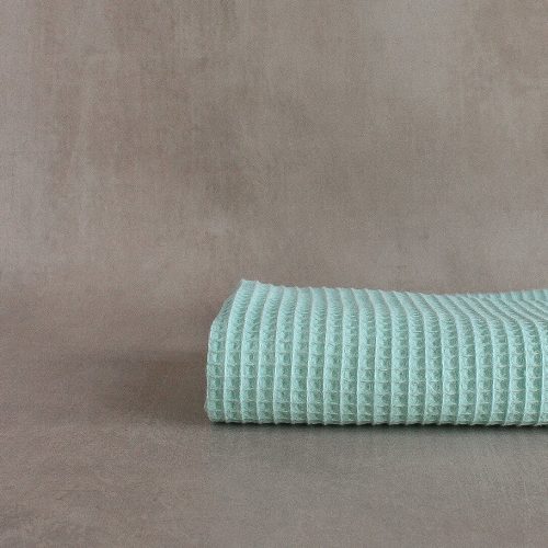 Cotton waffle fabric in cool mint folded