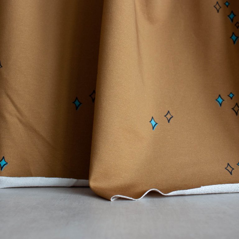 organic cotton french terry fabric in golden colour with stars