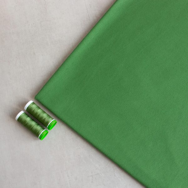 green organic cotton jersey fabric with 2 matching threads