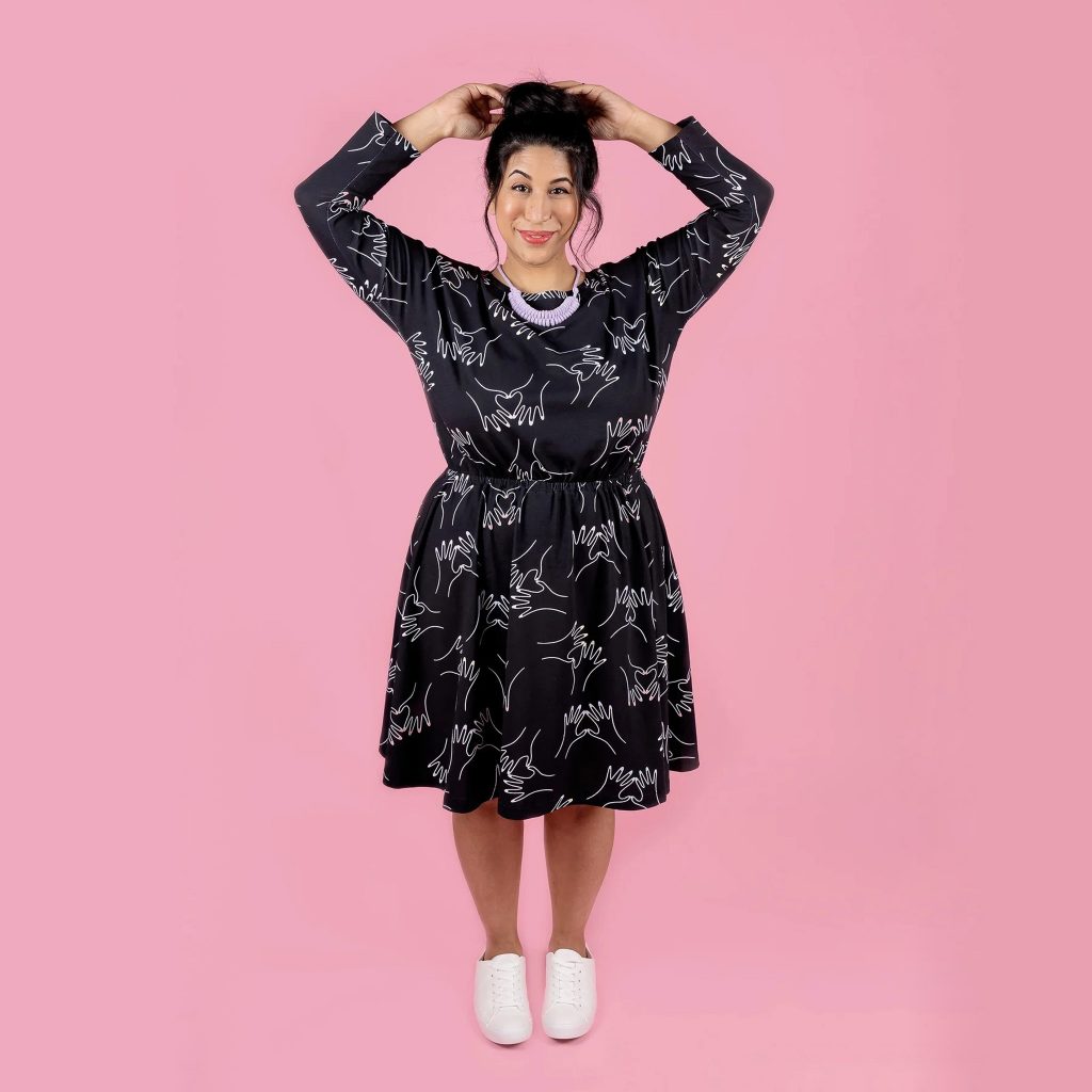 long sleeve dress in black on pink background