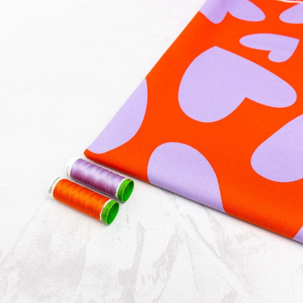 Cotton Denim Fabric with Stretch in Orange with Lilac Hearts