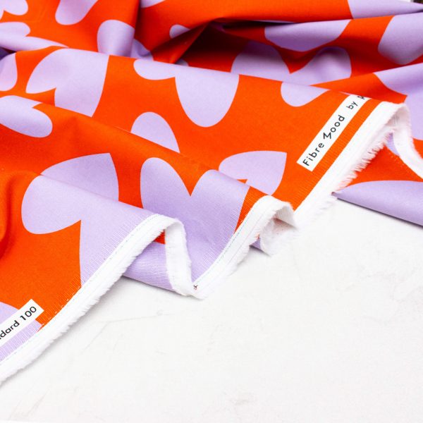Cotton Denim Fabric with Stretch in Orange with Lilac Hearts
