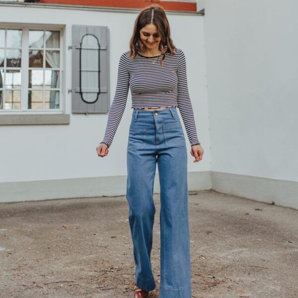 front view of heidi jeans sewing pattern in blue denim modelled by Jasmin