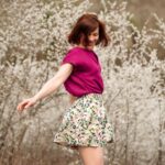 zoe wearing floral skirt and pink top