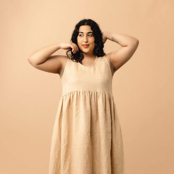 model wearing floaty dress with hands up