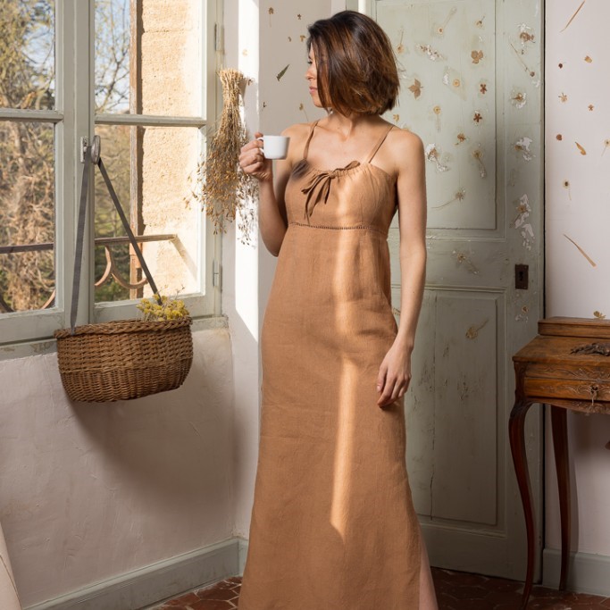 model wearing long brown dress with skinny straps