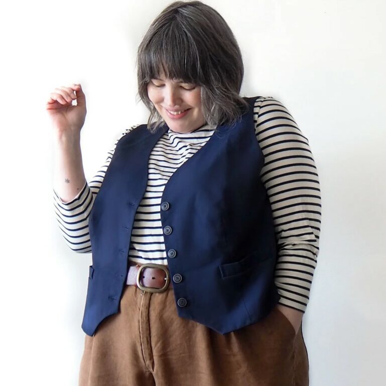 model wearing denim vest over stripey long sleeve top