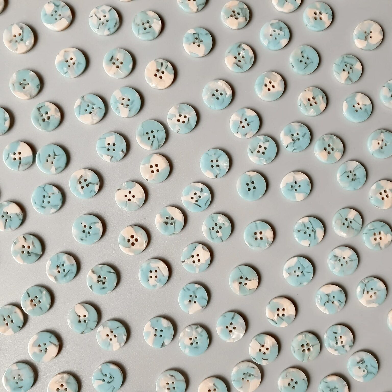 blue and white buttons scattered in an even pattern