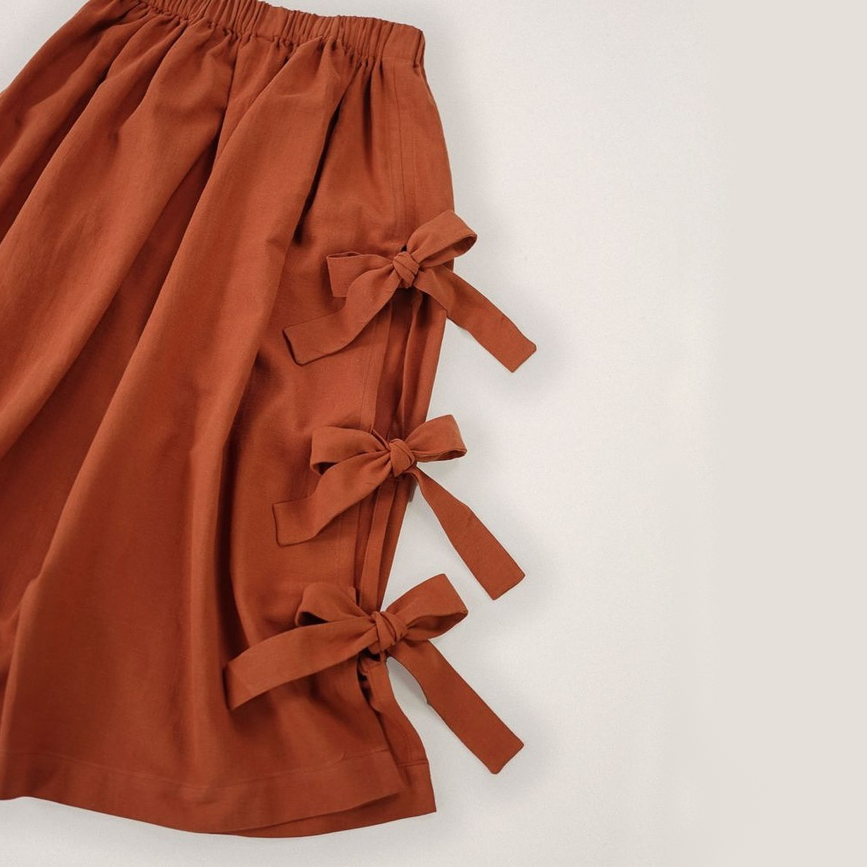 skirt sewing pattern with bows on a side in rust colour