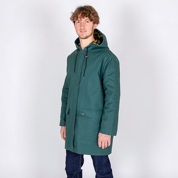 male model wearing teal blue raincoat
